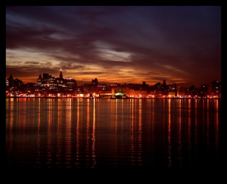 Nighttime Reflections: City Lights on Urban Waters