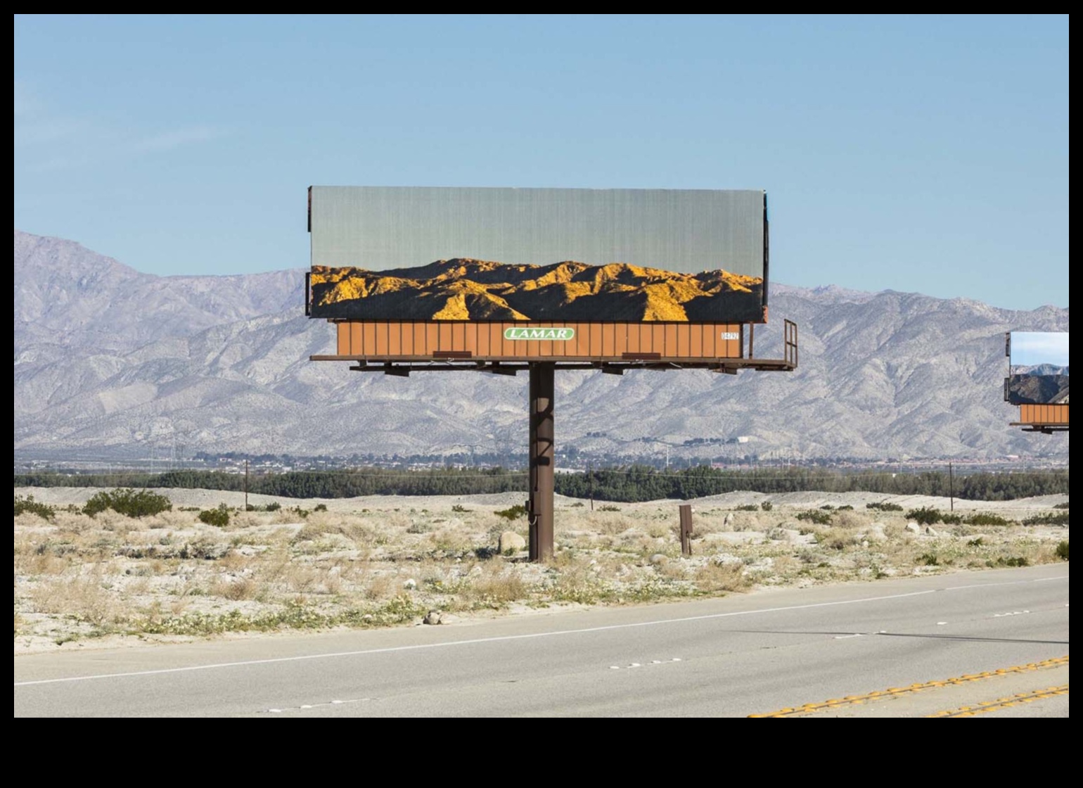 How do landscapes influence the design of outdoor advertising?